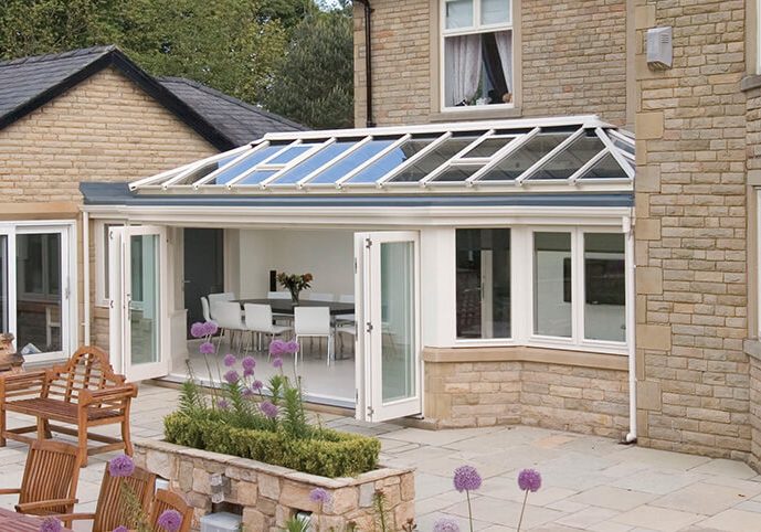 New Ultraframe uPVC orangery extension featuring large windows and a bright interior.